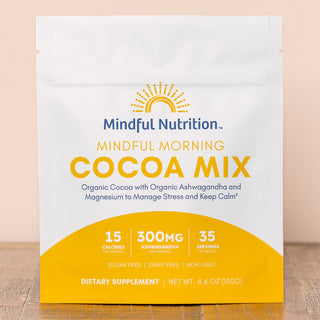 A pouch of Mindful Morning Cocoa mix by Mindful Nutrition, indicating 35 servings, 15 calories per serving, 300mg of ashwagandha, and that the product is sugar-free, dairy-free, and non-GMO.