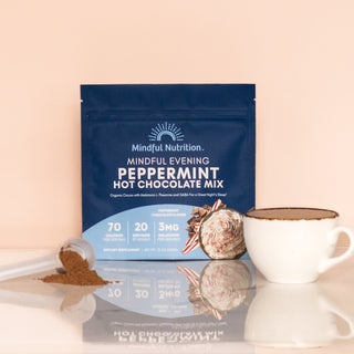 Mindful Nutrition Mindful Evening Peppermint Hot Chocolate Mix with melatonin, L-theanine, and GABA, shown with cocoa powder, a white mug, and peppermint candy