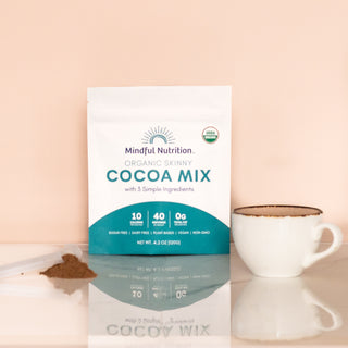 USDA organic skinny cocoa mix by Mindful Nutrition, styled with a scoop of powder and hot cocoa in a white mug