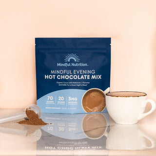 A pouch of Mindful Nutrition's Mindful Evening Hot Chocolate Mix with an image of a cup of hot chocolate with a scoop.